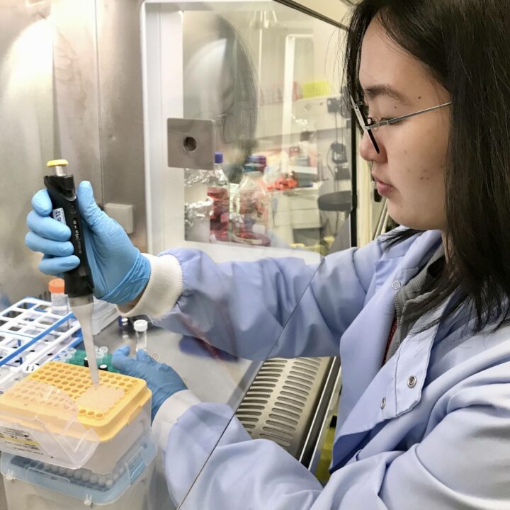 Jean Ling Tan using a pipette in a laboratory.