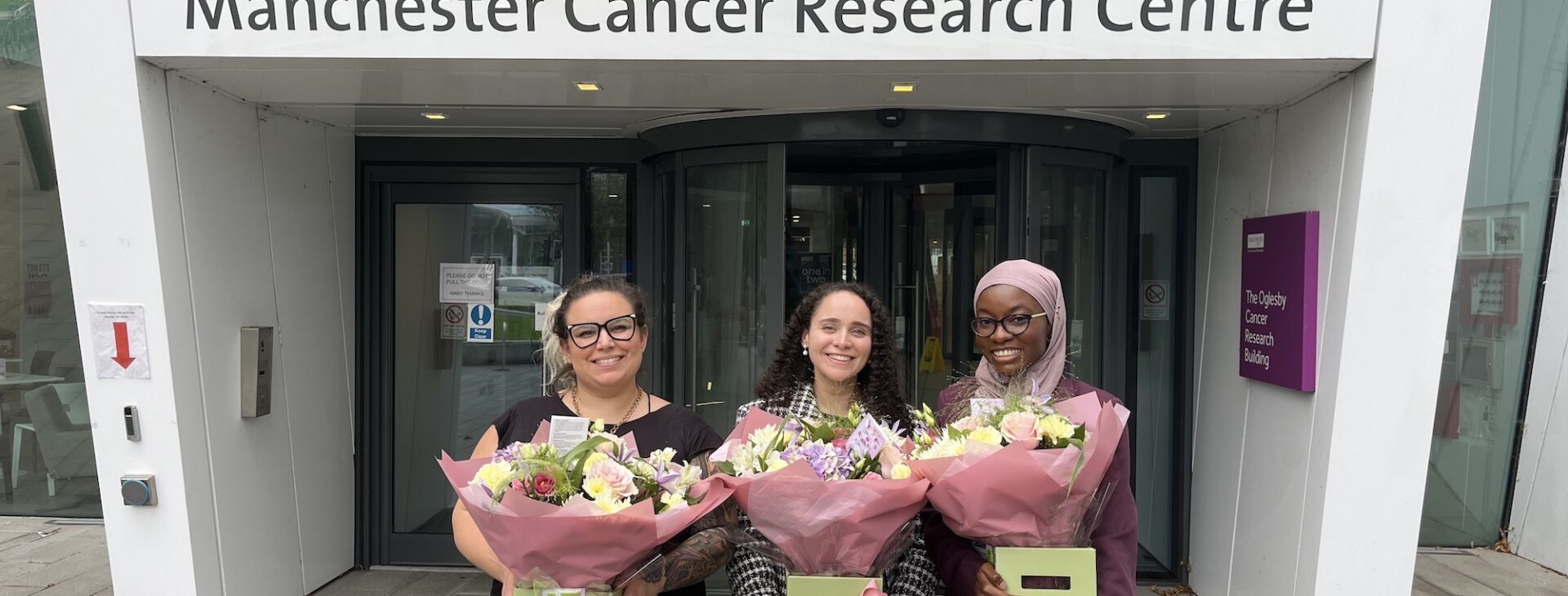 MB-PhD students in front of the OCRB in Manchester, Left to right: Macarena, Nadin, Hadiyat