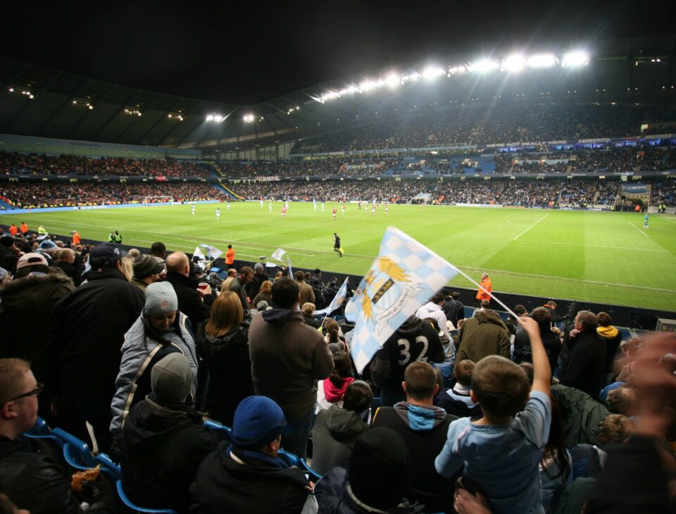 Fans watching Manchester City Football Club at the Etihad Stadium