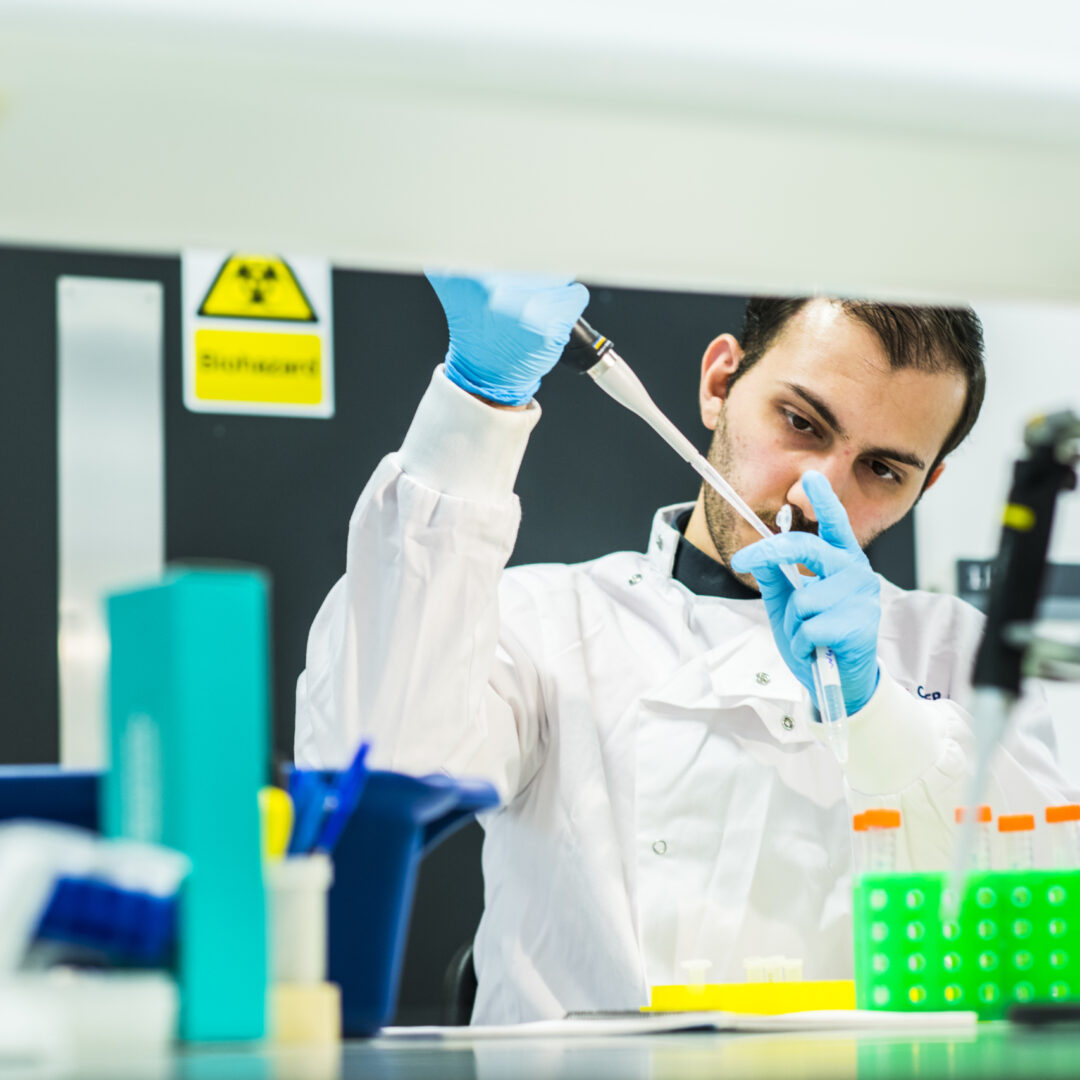 An MB-PhD student using a pipette